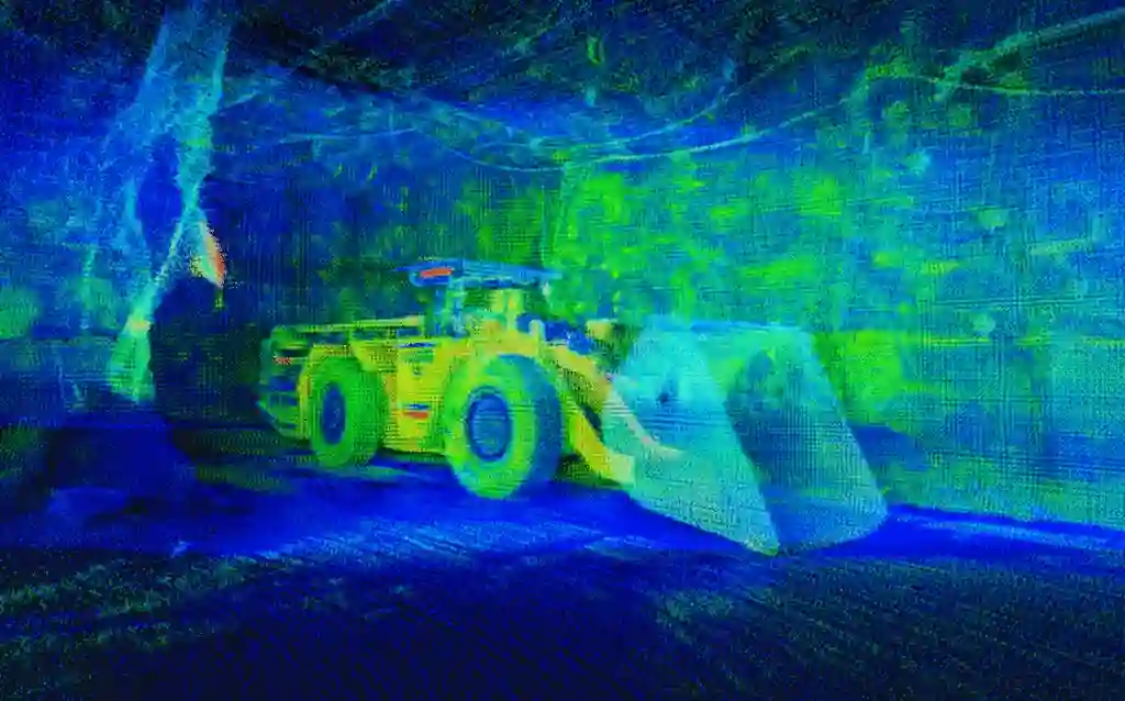 A high-resolution 3D point cloud visualization of an underground mine ramp captured by SafeScanner. The image shows a dense, color-coded digital twin of the decline, clearly defining the rock face geometry, floor gradients, and installed infrastructure. The data is sharp and free of noise, demonstrating the precision of in-motion mapping for volume reconciliation and vehicle clearance analysis.